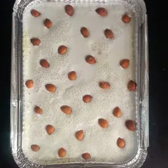 A family-sized foil tray of our Apricot Delight, topped with almonds. This is a convenient option for takeaway orders, ensuring you can enjoy this luscious dessert at home.