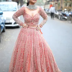 The intricate silver work on this red lehenga shines beautifully. It's a heavy, luxurious piece that feels amazing to wear.