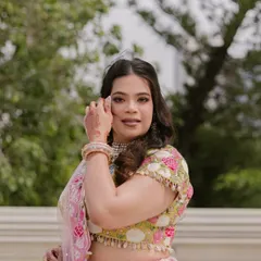 A candid shot of the bride during her mehendi, her natural beauty enhanced by a soft glam makeup look.