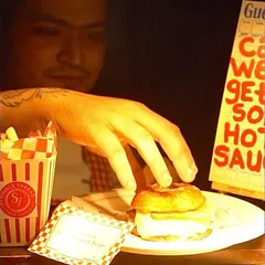 My live burger stations are always a crowd-placer. A chef carefully assembles a gourmet smash patty burger, complete with all the fixings, showcasing the hands-on, fresh-to-order quality of my interactive catering.