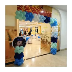 A simple and sweet balloon arch at the entrance to a Little Krishna themed party. The personalized photo sign is a lovely touch.