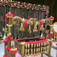 An ornate cradle (thottilu) decorated for a naming ceremony. I used garlands of jasmine and pink flowers, with hanging lotus buds to create a beautiful and auspicious centerpiece for the event.