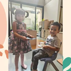 Grace and Courtesy are taught as practical life skills. Here, a child learns to serve a guest, a simple act that teaches empathy, respect, and social awareness.