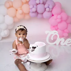 Nothing says "first birthday" like a cake smash! This shot captures the pure, messy joy of a baby digging into their cake for the first time.