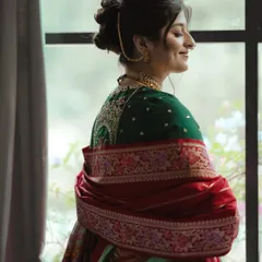 A side profile of the Maharashtrian bride, showing the elegant shape of her bridal bun and how it works with her paithani saree.