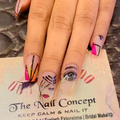 A unique, abstract design on a single long nail. This piece of art features a hand-painted eye, lips, and geometric patterns in multiple colors.