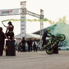 The stunt show is a full sensory experience, with riders performing wheelies amidst clouds of green smoke. It's a visual spectacle that creates unforgettable photo opportunities.