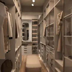 Another perspective of a luxurious walk-in closet, showing a mix of open and glass-fronted cabinetry. A central bench and a full-length mirror add to the boutique-like feel.