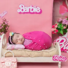 A real-life Barbie girl! This all-pink, Barbie-themed newborn shoot is perfect for your little princess, complete with a miniature bed and accessories.