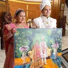 A happy couple posing with their finished live wedding painting. Their smiles show the delight of receiving such a personal and artistic memento of their big day.
