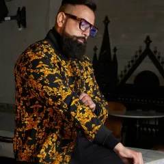For the man who is unafraid to be bold, I design pieces that command attention. This baroque-patterned bomber jacket in black and gold offers a luxurious and confident style, proving that casual outerwear can still be a work of art.