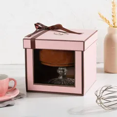 Our single dessert gift box in pink, featuring a clear window to showcase the Dark Chocolate Mousse inside. The box is finished with a simple, elegant brown ribbon.