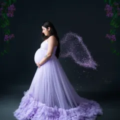 An angelic portrait for a magical time. We added a touch of creative editing to this lavender gown photo to give the mom-to-be beautiful, sparkling wings.