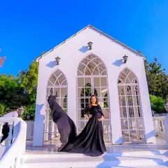 This is for the mothers who want a touch of drama and elegance. We chose an outdoor location with striking architecture to complement this beautiful flowing black gown, creating a powerful and timeless maternity portrait.