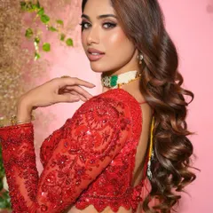 A side profile highlighting the beautiful hairstyle and the flawless contour of her makeup. This look is all about sophisticated glamour.