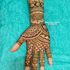 For the bride who wants to shine without heavy designs. This elegant bridal mehndi features delicate elephants, paisleys, and floral bands.