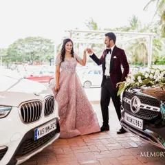 The power couple posing with their cars. This shot shows the full elegance of Surabhi's engagement gown and the groom's sharp attire.