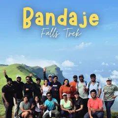 Our happy group at the summit of the Bandaje Falls trek, celebrating their accomplishment with the stunning green hills in the background.