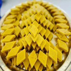A beautiful pyramid of freshly made Badam Katli. This classic sweet, made from almonds, is a premium offering that adds a touch of luxury to any dessert spread.