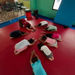 A moment of calm during our yoga session on Day 1 of camp. Our little yogis practice the child's pose together in a circle.