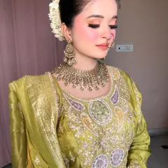 A side view showing the elegant bun adorned with a fresh white gajra, a classic touch for any traditional look.