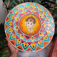 A vibrant Ganesha Lippan art piece on a 16 inch wooden board. The colorful mandala pattern and mirror work create a festive and auspicious energy, perfect for any home.