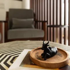 Beauty is in the details. The stunning mother-of-pearl inlay coffee table, paired with a handcrafted Nandi sculpture, adds a touch of Indian elegance and sophistication.