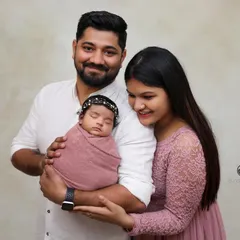 A classic first family portrait with a newborn. Our studio sessions provide a timeless look, focusing on the connection between new parents and their baby.