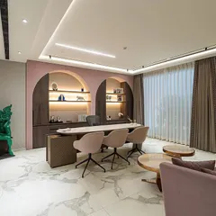 A wider view of the executive office, showcasing the balance between the powerful desk area and the comfortable seating nook. The dusty rose color palette and soft materials create a welcoming environment that reflects both legacy and feminine strength.