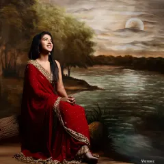 A full view of the maroon georgette saree against an artistic backdrop. This is a classic and elegant choice for a reception or formal family function.