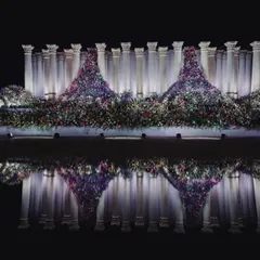 We don't just build structures; we create art. For this reception, we installed 22-foot Roman pillars and set them against a water body to create this stunning reflection. It's about achieving that unconventional balance between simple, grand, and dramatic.