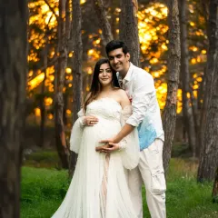 There's nothing like the magic of golden hour. This outdoor maternity session captures a couple's love in the warm, dreamy light of a forest setting, creating a truly romantic and timeless memory.