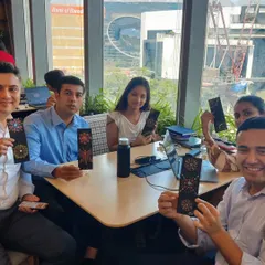 A small group from the Colliers team, seated together and proudly holding up their finished dot painting bookmarks. It’s in these shared moments, away from screens and deadlines, that genuine team connection happens.