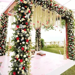 This outdoor mandap is wrapped in dense columns of red and white roses with hanging floral strings for a classic look.