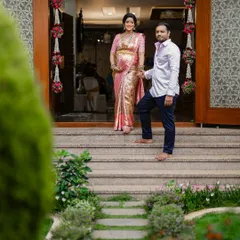 A beautiful portrait of the expecting parents at the entrance of their home, ready to welcome their new chapter.