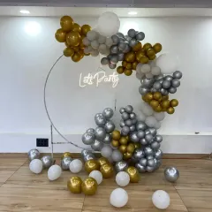 Another angle of the silver and gold ring backdrop, showing some loose balloons scattered on the floor to extend the decorative effect.