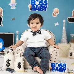 A classic Boss Baby pose. This little guy looks ready to take over the boardroom in his sharp bow tie and confident expression.