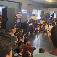 It's not just about battling, it's about learning. Here, dancers listen intently during a session at the Red Bull BC One qualifier, absorbing knowledge from the judges and mentors.