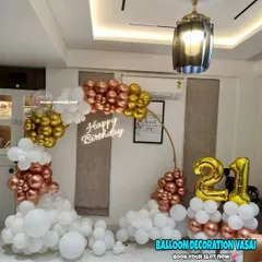 Celebrating a 21st birthday with a touch of class. This elegant ring backdrop is decorated with a cascade of rose gold, gold, and white balloons, complete with a "Happy Birthday" neon sign for a modern look.