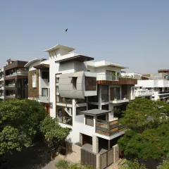 The Ashraya Residence, seen from an aerial perspective, reveals its complex composition of interlocking blocks and terraced gardens. This design is a modern interpretation of traditional Indian terraced farming, creating a home that is both sculptural and deeply connected to its site.