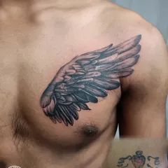 Before and after of a chest cover-up. A small, old tattoo is completely hidden by a beautifully shaded angel wing, giving the client a fresh and powerful new piece.