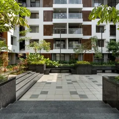 The courtyard at Sona Vistaas is designed as a dynamic community hub. The multi-level design, combining hardscape and softscape, creates a variety of spaces for different activities, catering to all age groups.
