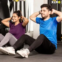 Working on core strength together. This couple is doing synchronized sit-ups, making the exercise more fun and motivating.