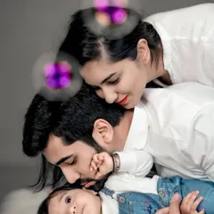 Adding a touch of magic with bubbles. This playful variation of a family portrait captures the wonder and joy as they share a loving moment with their baby.