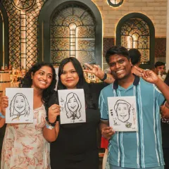 Fun and engagement at a corporate gathering. Guests show off their caricature portraits, a unique entertainment option that I can help arrange to make your event more memorable.