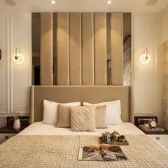 A master bedroom should be a serene retreat. For this contemporary bedroom, I used warm neutrals, plush textures, and elegant lighting to create an inviting ambiance. The tall, upholstered headboard with vertical paneling serves as a sophisticated focal point.