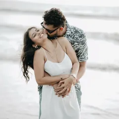 A candid moment of laughter and love. This photo captures a genuine smile during a pre-wedding shoot on the beach, showing the happy, relaxed atmosphere I create.