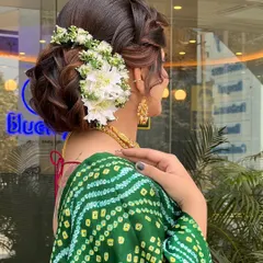 Another angle of the elegant floral updo, highlighting the smooth finish and the structure of the bun that ensures it holds perfectly throughout the event.