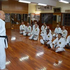 Here, a group of senior practitioners and I listen to the teachings of Grand Master Zenpo Shimabukuro in his dojo. Learning directly from the head of our style is an invaluable experience.
