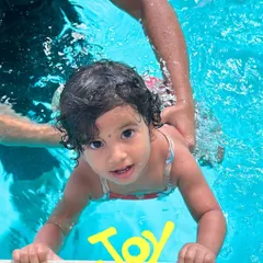 The pure joy on this little swimmer's face says it all. We focus on creating positive first experiences in our warm, ozonized pool.